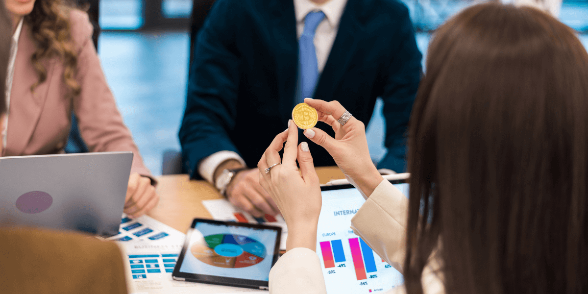 female-worker-holding-a-physical-cryptocurrency-coin-in an-office